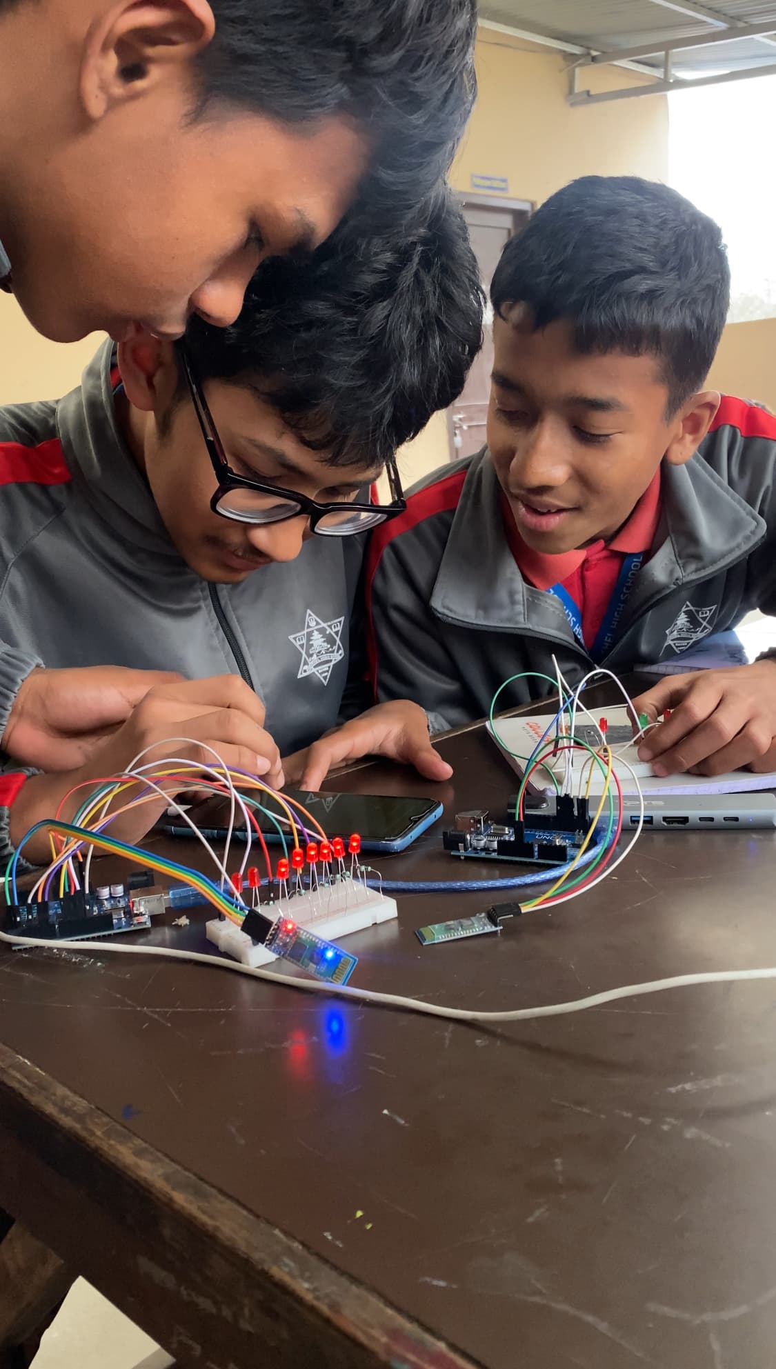 IHR students working on robotics projects in the lab